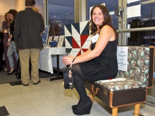 Angie Brothers checking out the "Suitcase Chair" auction item